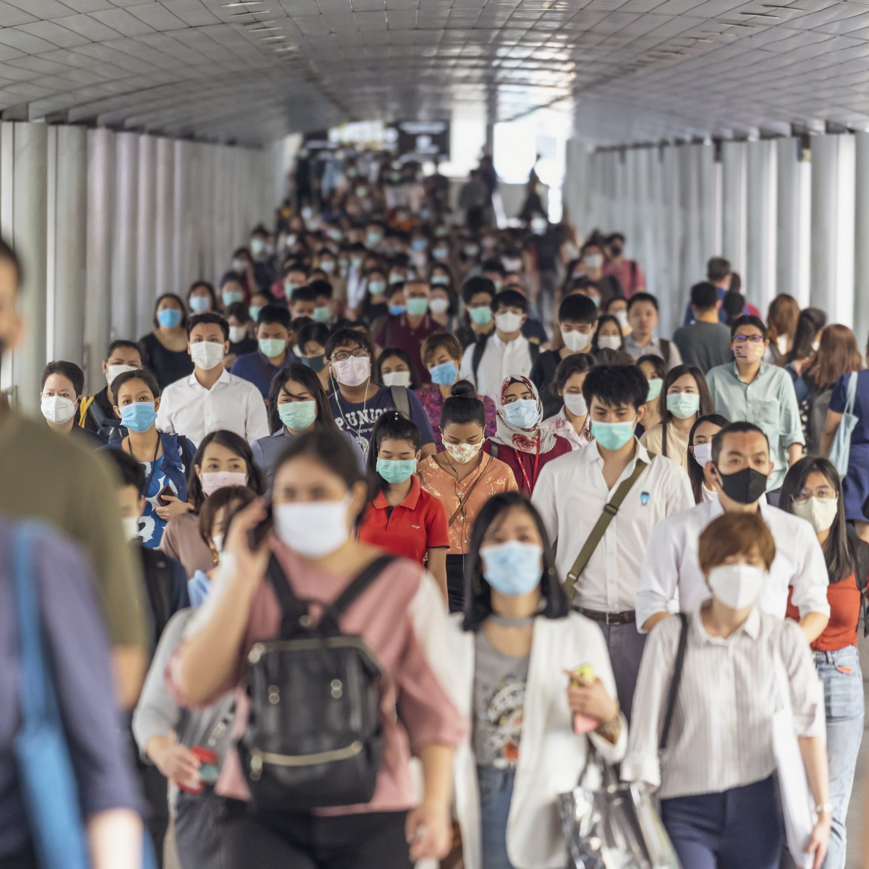Bangkok, Thailand - Mar 2020 : Crowd of unrecognizable business people wearing surgical mask for prevent coronavirus Outbreak in rush hour working day on March 18, 2020 at Bangkok transportation